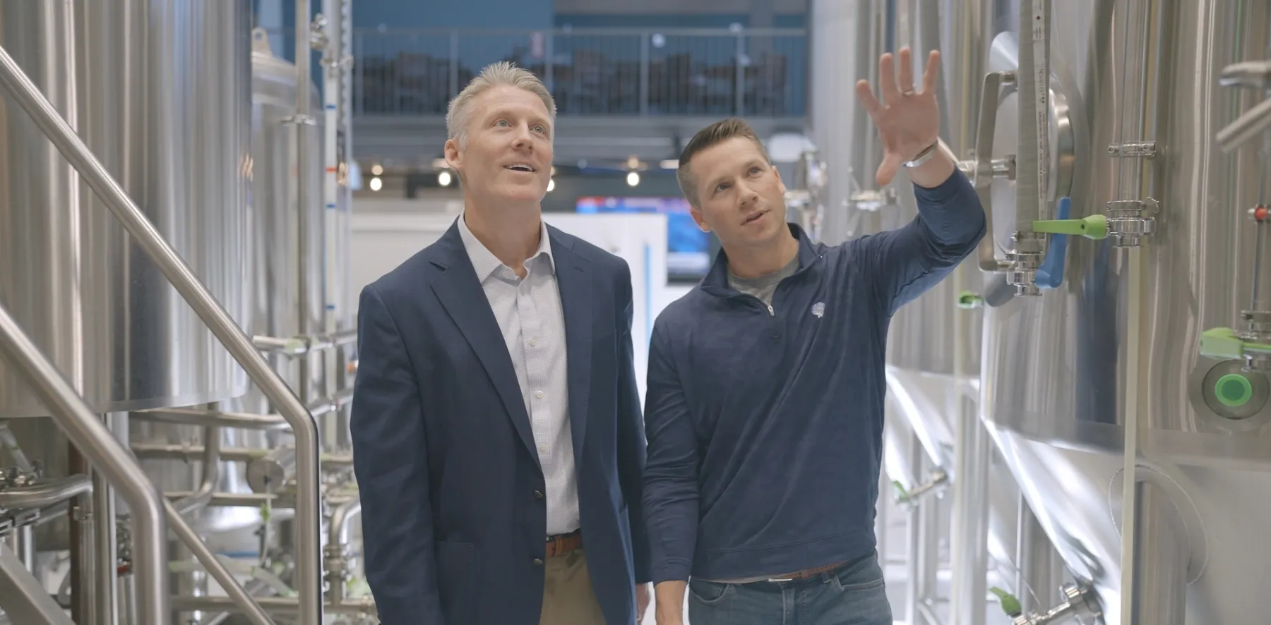 Advisor and customer walking through brewery