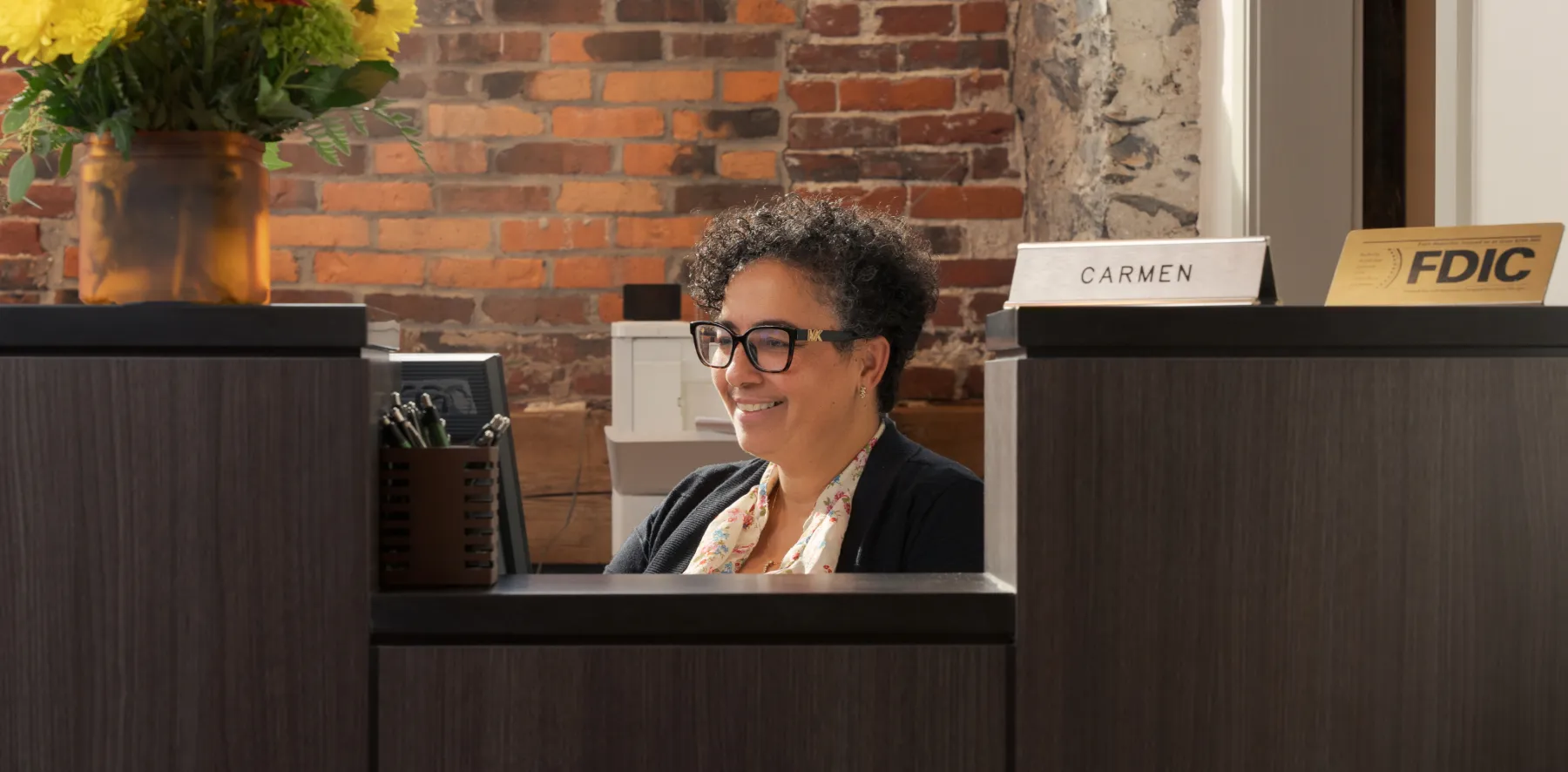 Bank teller sitting at desk