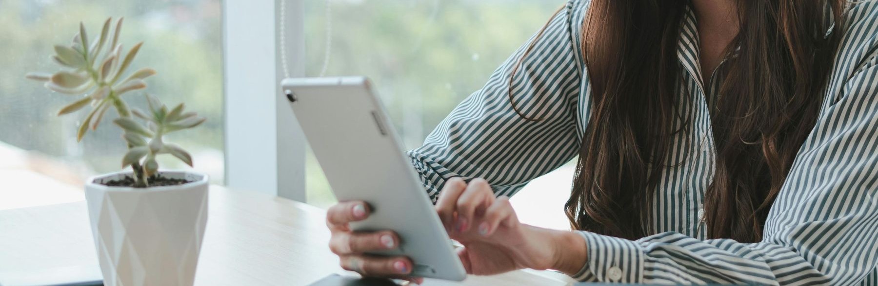 Woman's hands holding a tablet