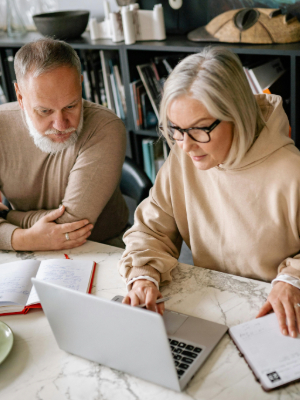 Elderly couple looking at laptop
