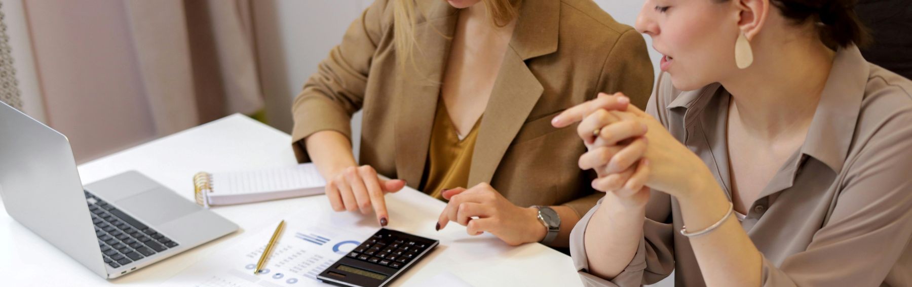 People using calculator and discussing finances