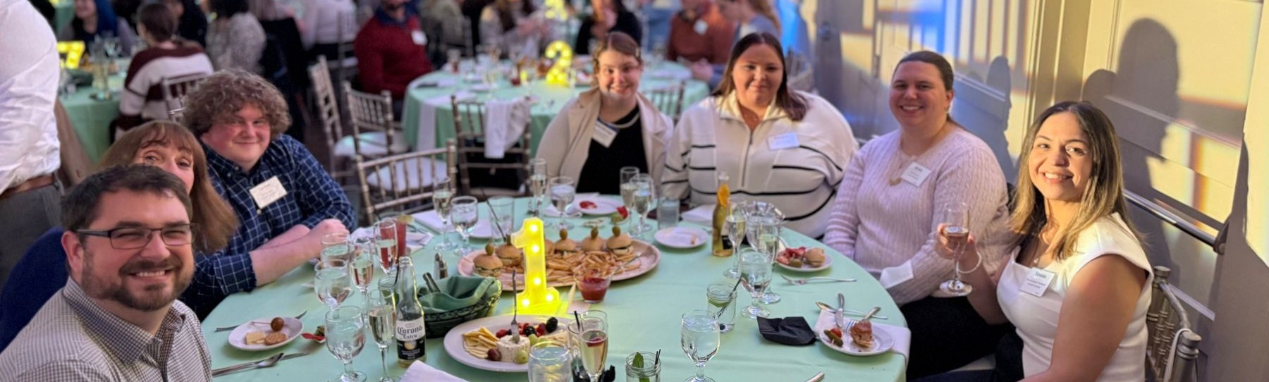 Employees around dinner table at a party