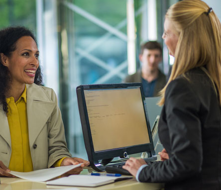 Lowell Five Relationships - a woman at the counter of a bank